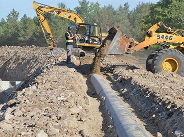 Workers from the contracting company Xterra put finishing touches on a new trench system in the Arkell Spring Grounds, east of Arkell